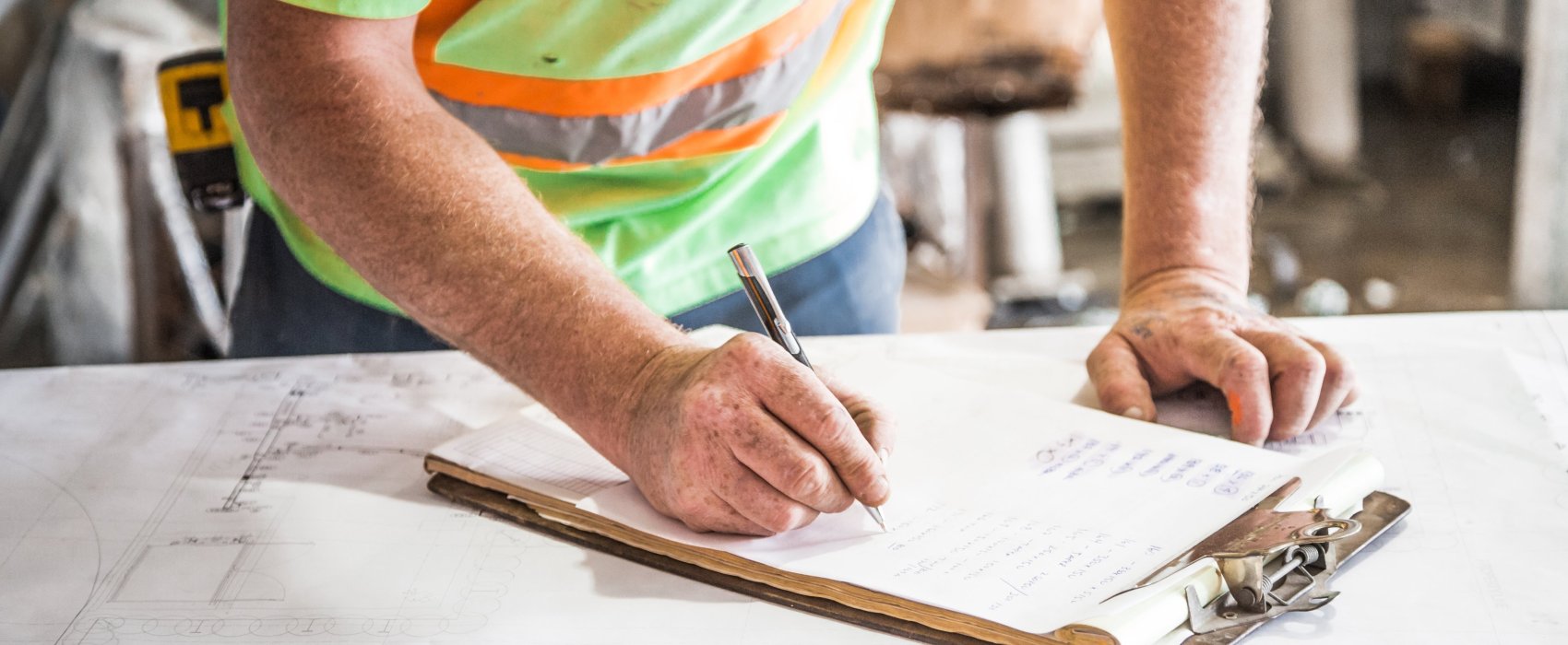 person writing on clipboard