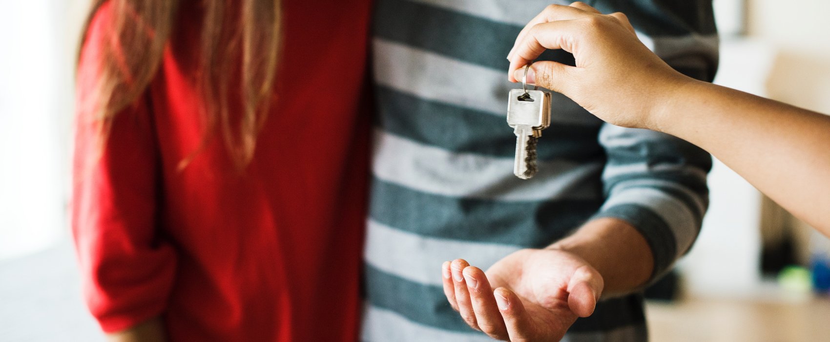 couple behind handed keys