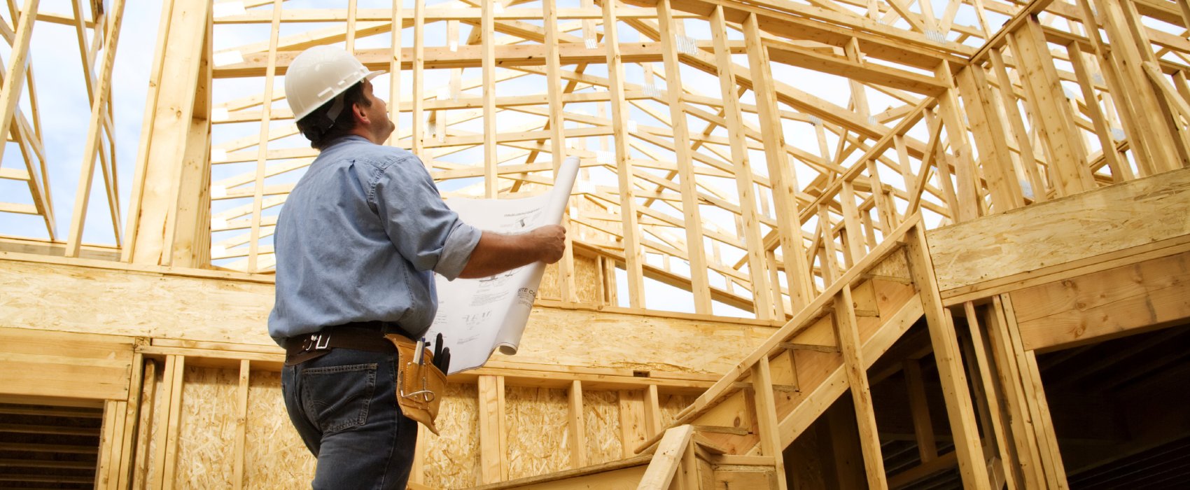 Construction worker assessing structure