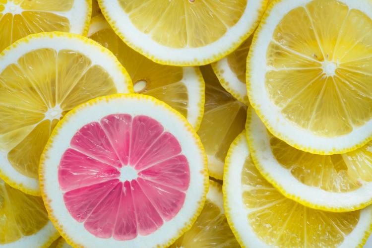 pink citrus slice among yellow lemon slices
