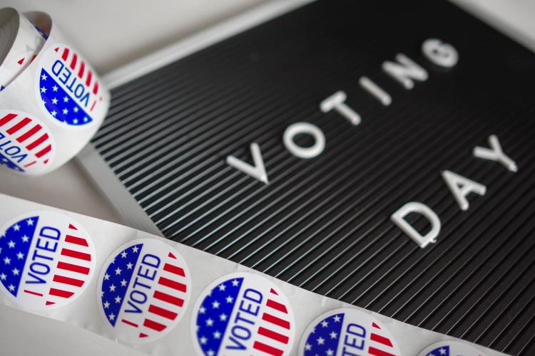 "I voted" stickers and a sign that says "voting day"