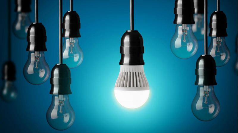 light bulbs dangling in front of a blue background