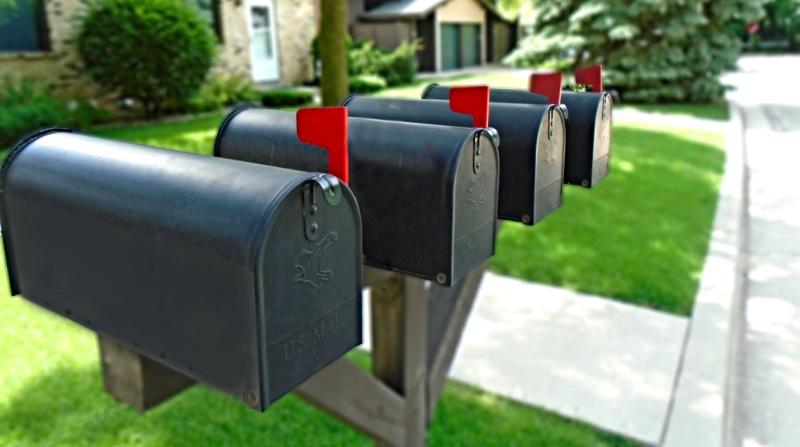 black mailboxes with red flags