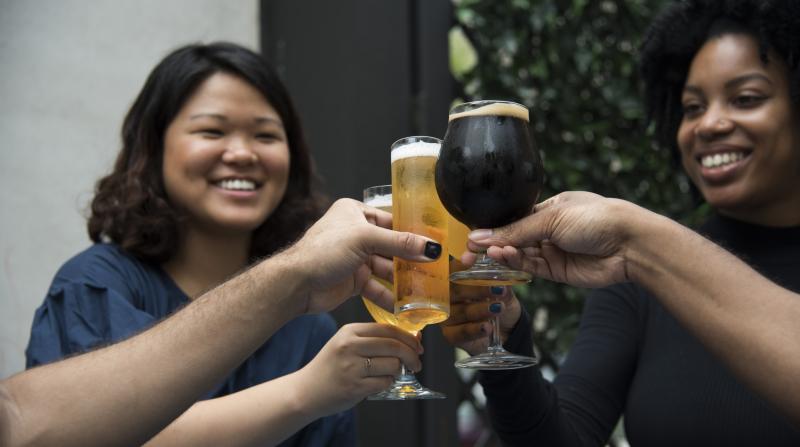 women cheers with beer glasses