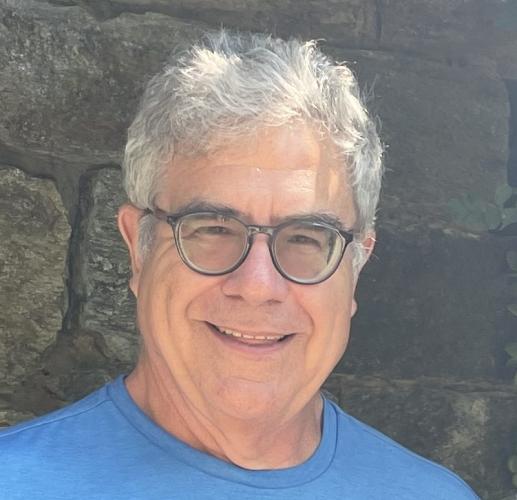 Image of Bill Burns in front of a stone wall