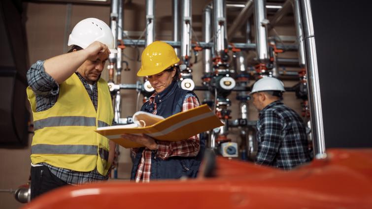 building operators looking at a manual