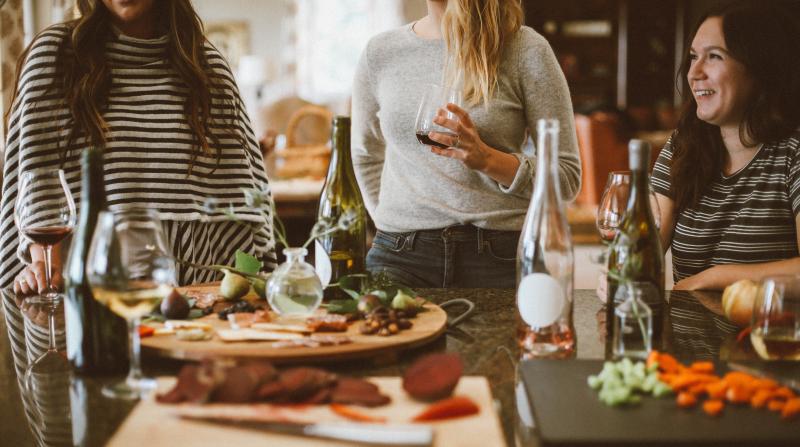 people drinking wine and eating cheese