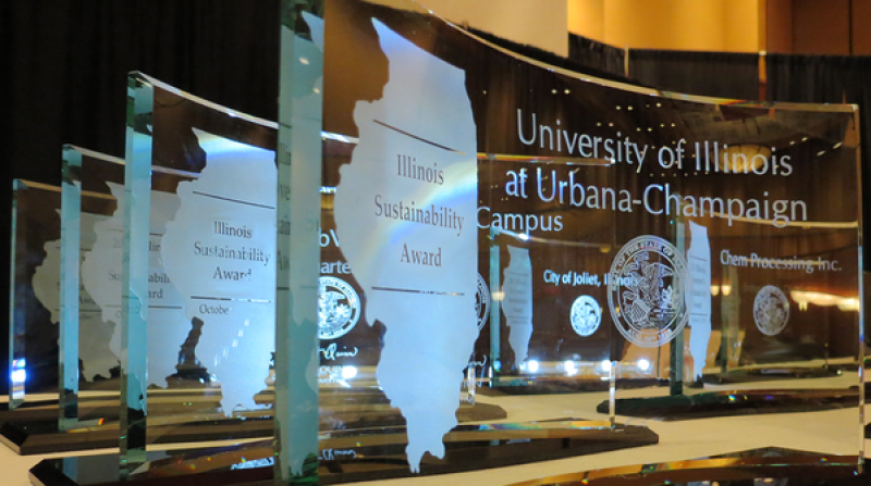 closeup of IL sustainability awards trophies with state of Illinois etched on glass
